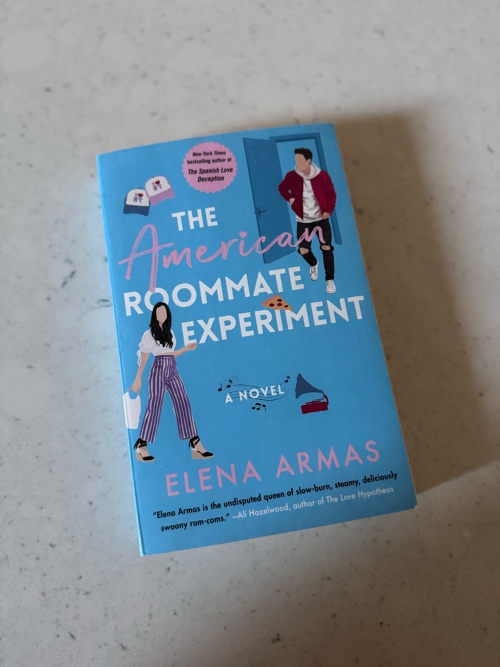 The American Roommate Experiment by Elena Armas - Bright Blue Paperback book